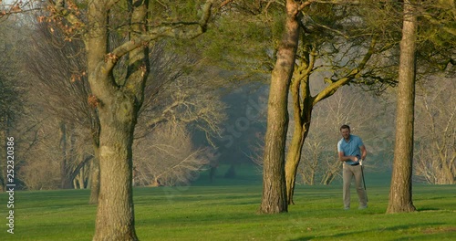 Fore!  A Golfer plays a shot out of the trees and hits his golfing buddy!  The Golfer puts his hand over his mouth in disbelief!