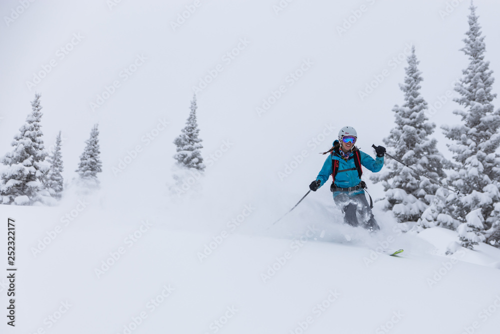 Female skier turning in powder