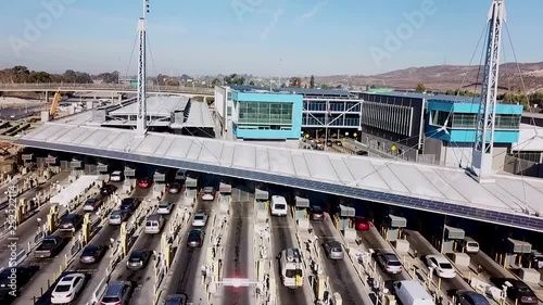 2018 - rising aerial over the San Ysidro Tijuana US Mexico border crossing with cars lined up for miles.