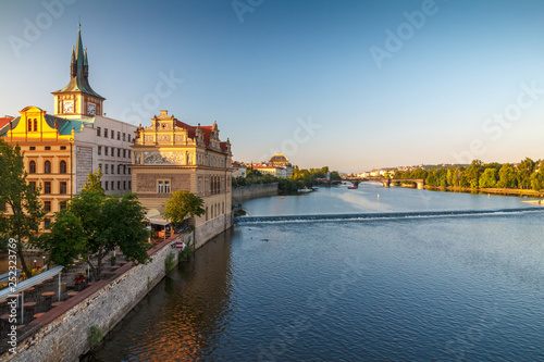 Vltava river and waterfront of the old town with the theater in Prague at sunrise, Czech Republic, Europe. © Viliam