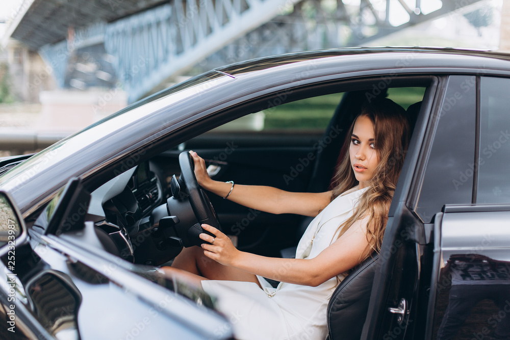 Luxury professional fashion model with new sport car outdoors. Fashion, transport, luxury concept Luxury professional fashion model with new sport car outdoors. Fashion, transport, luxury concept