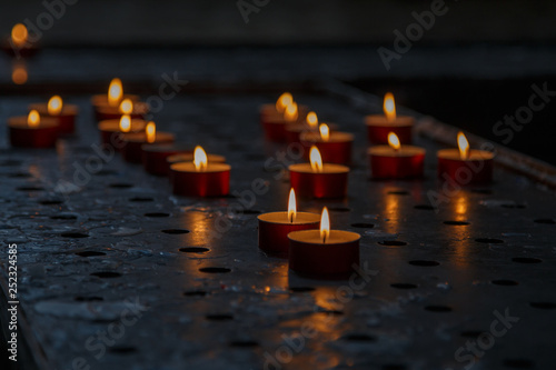 Burning candles on table in church