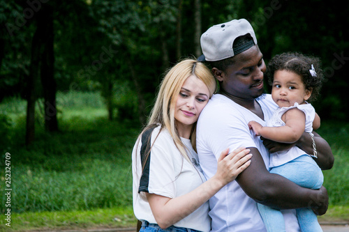 Happy diverse family with daughter at park. Beautiful Diverse Family