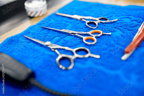 set of barber scissors on a blue towel 