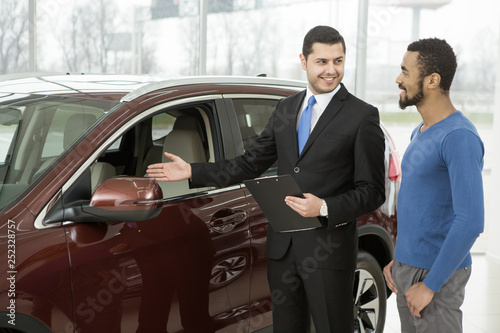 Young African man buying a car from a professional salesman © Zoriana