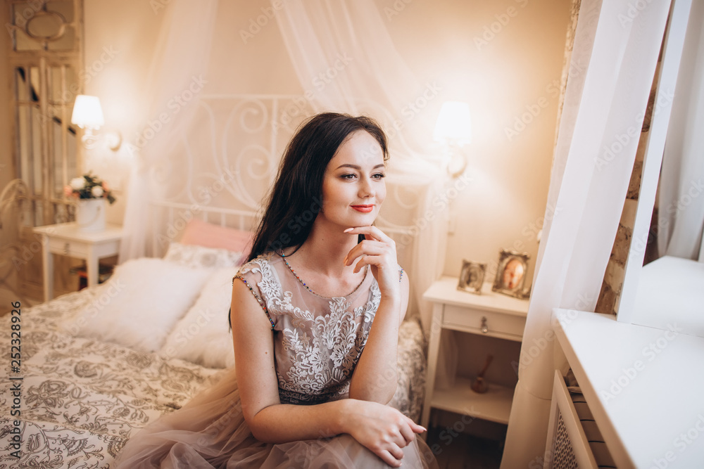 Tender elegant bride in wedding dress. Fashion beauty brunette girl preparing for a marriage Tender elegant bride in wedding dress. Fashion beauty brunette girl preparing for a marriage