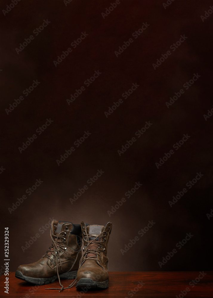 Old Work Boots On Brown Background With Copy Space Vertical