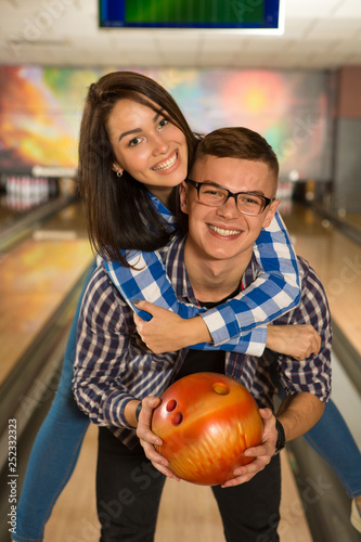 Beautiful happy couple bowling together at the local club
