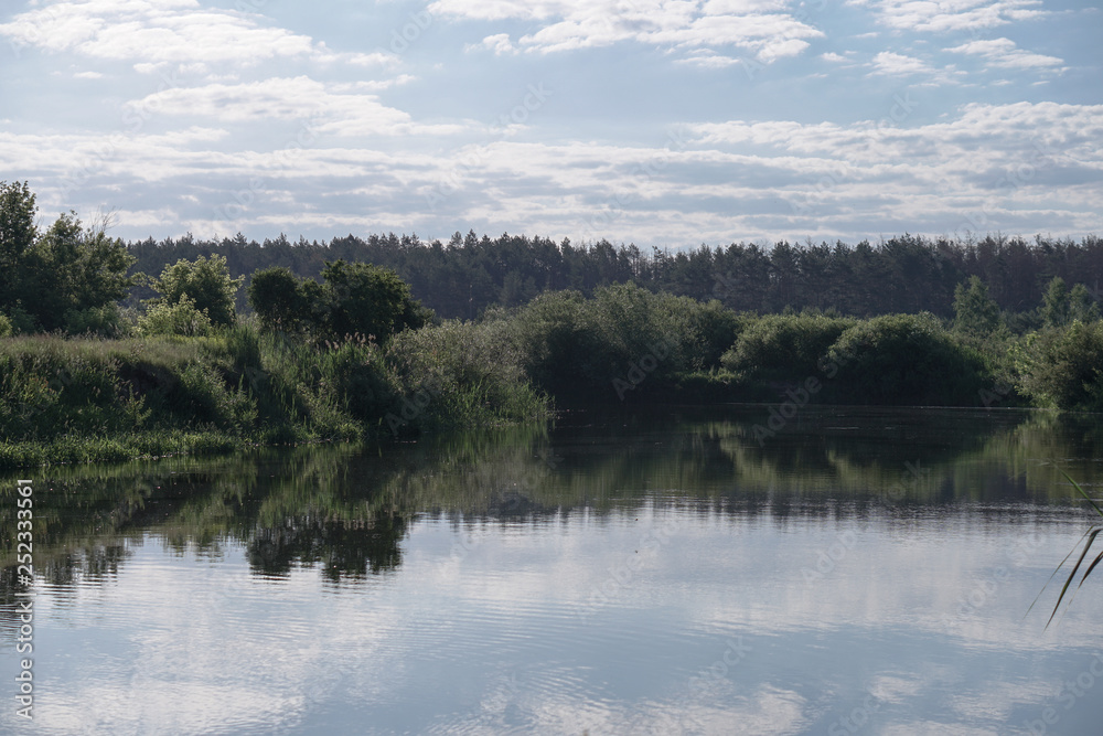 Pretty river in rural areas. European landscape of Russia and Siberia. Beautiful tranquil view of nature. Stock background, photo.