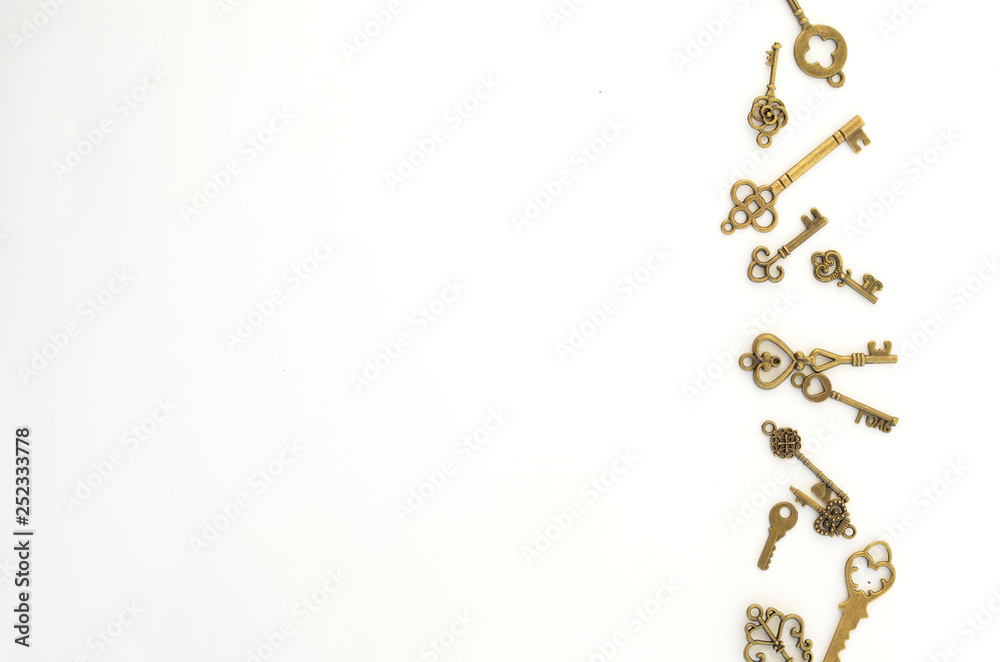 Decorative keys of different sizes, stylized antique on a white background. On the right border of the frame Decorative keys of different sizes, stylized antique on a white background. On the right border of the frame