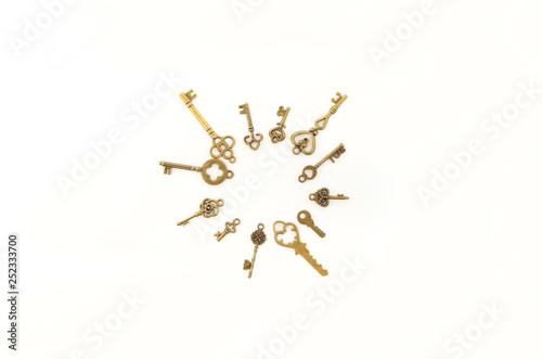Decorative keys of different sizes, stylized antique on a white background. Form the centerpiece. Circle, sun