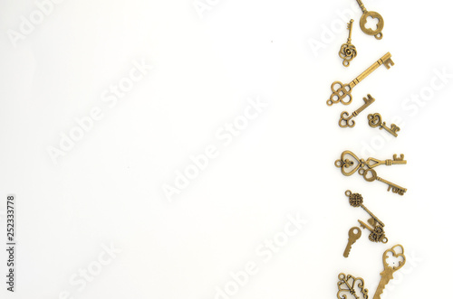Decorative keys of different sizes, stylized antique on a white background. On the right border of the frame