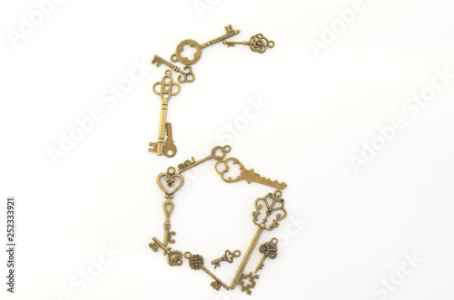 Decorative keys of different sizes, stylized antique on a white background. Form the centerpiece. Numeral