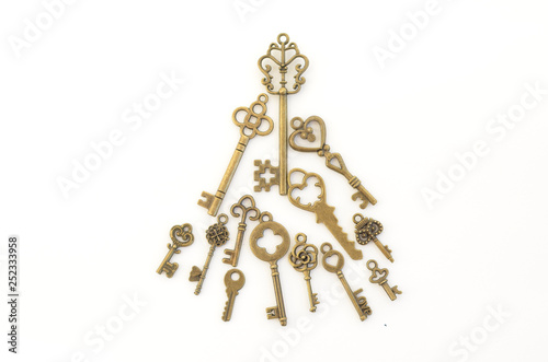 Decorative keys of different sizes, stylized antique on a white background. Form the centerpiece. Christmas tree
