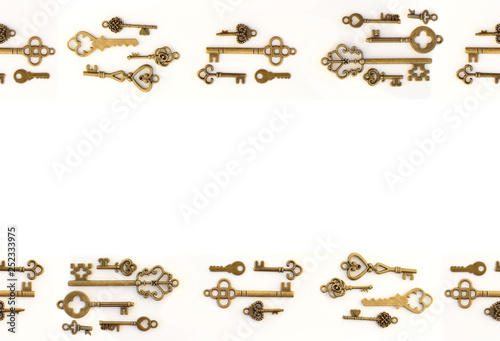 Decorative keys of different sizes, stylized antique on a white background. Form the centerpiece. At the top and bottom of the frame