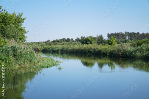 Pretty river in rural areas. European landscape of Russia and Siberia. Beautiful tranquil view of nature. Stock background  photo.