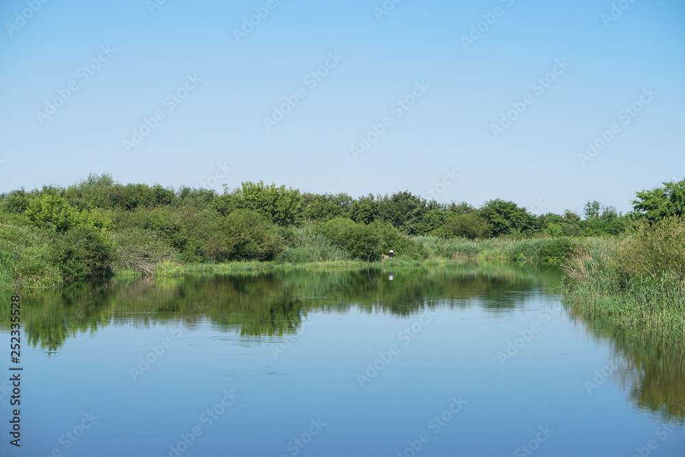 Pretty river in rural areas. European landscape of Russia and Siberia. Beautiful tranquil view of nature. Stock background, photo.