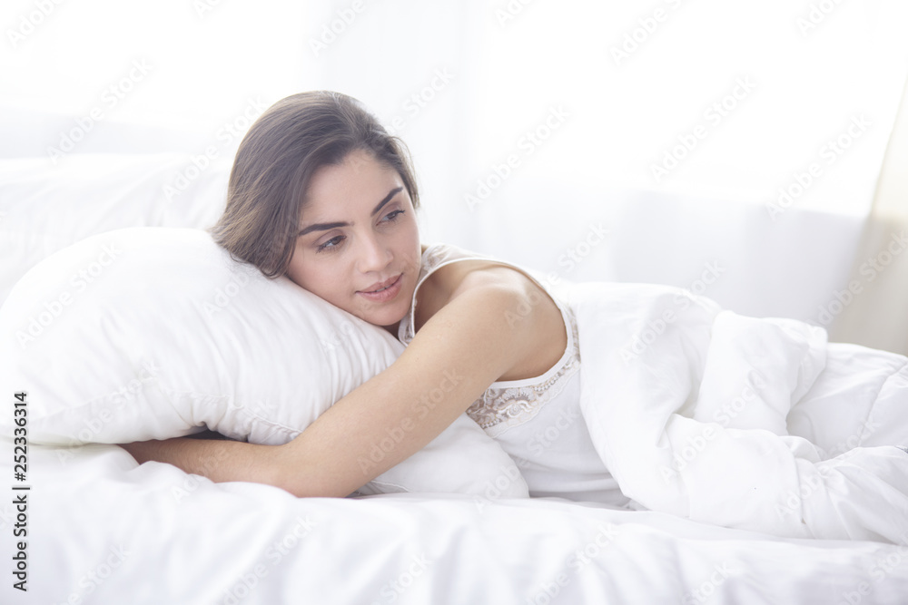 beautiful young woman basking in bed in the morning. Beautiful Model face looks sexy in camera beautiful young woman basking in bed in the morning. Beautiful Model face looks sexy in camera