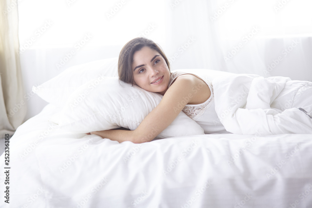 beautiful young woman basking in bed in the morning. Beautiful Model face looks sexy in camera beautiful young woman basking in bed in the morning. Beautiful Model face looks sexy in camera