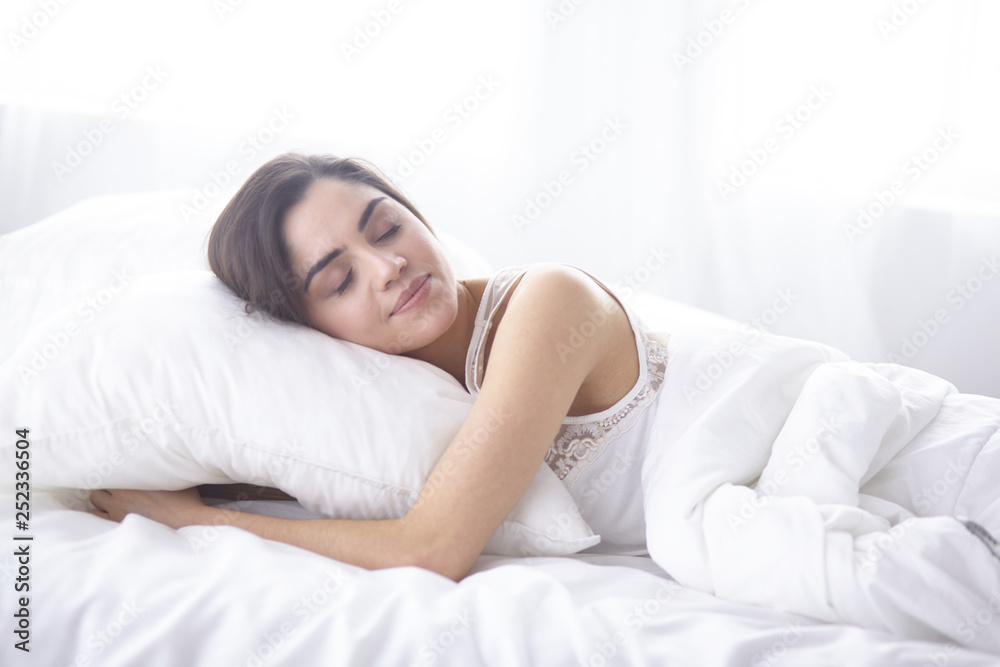 beautiful young woman basking in bed in the morning. Beautiful Model face looks sexy in camera beautiful young woman basking in bed in the morning. Beautiful Model face looks sexy in camera