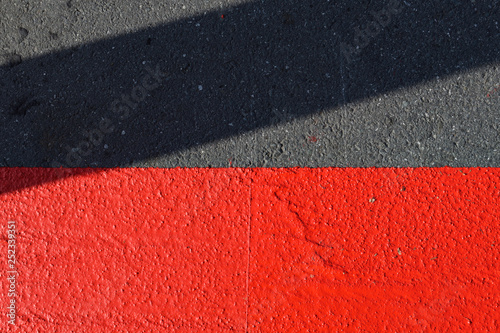 red road marking with shadow