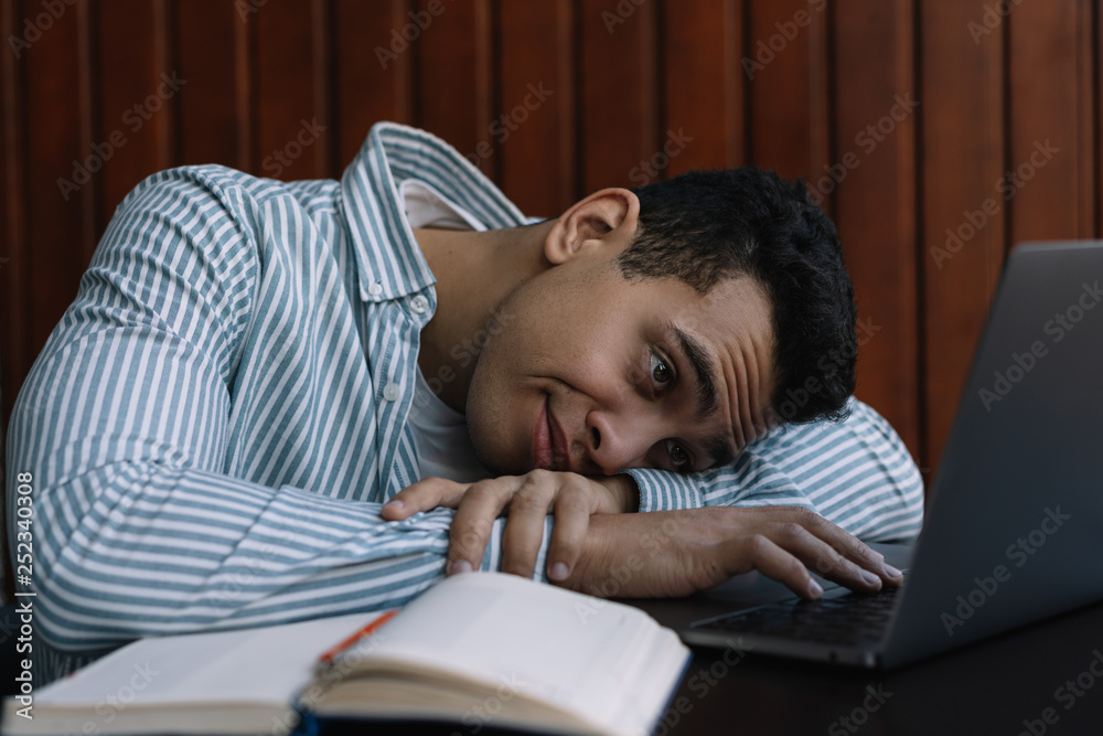 Busy African American man using laptop computer, typing on keyboard. Depression. Tired. Stress. Freelancer working project, missed deadline, overtime job. Frustrated businessman sitting in office Busy African American man using laptop computer, typing on keyboard. Depression. Tired. Stress. Freelancer working project, missed deadline, overtime job. Frustrated businessman sitting in office