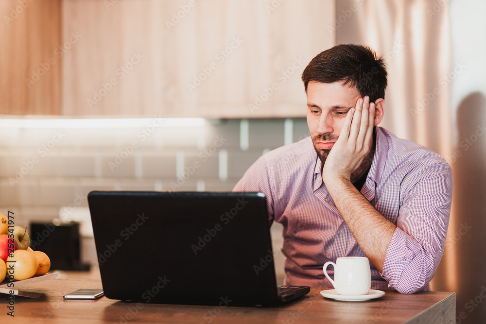 Young businessman working on a laptop at home Young businessman working on a laptop at home
