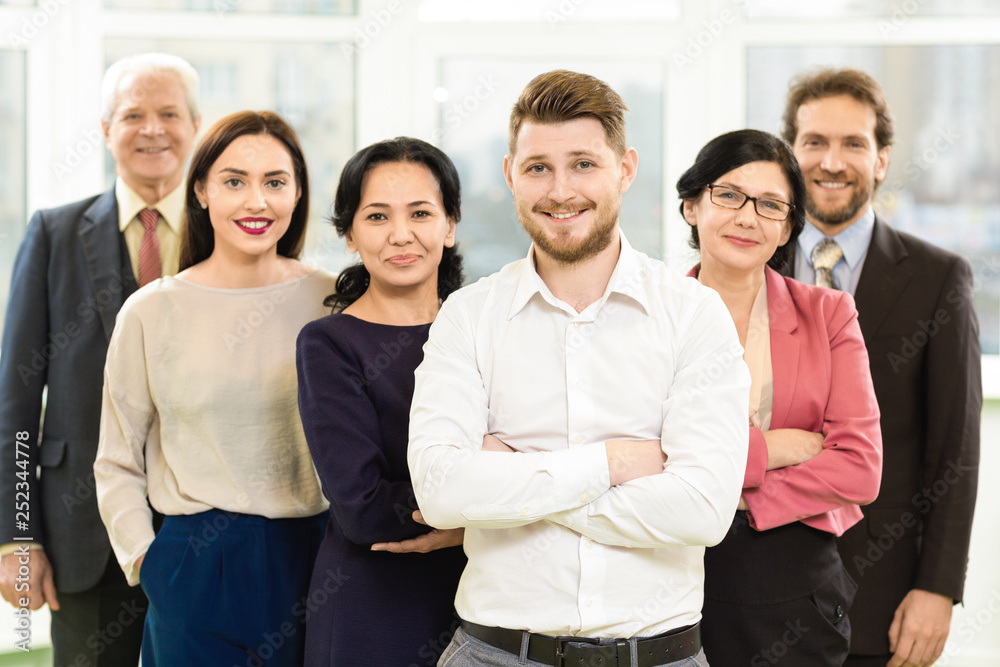 Group of cheerful businesspeople at the office Group of cheerful businesspeople at the office