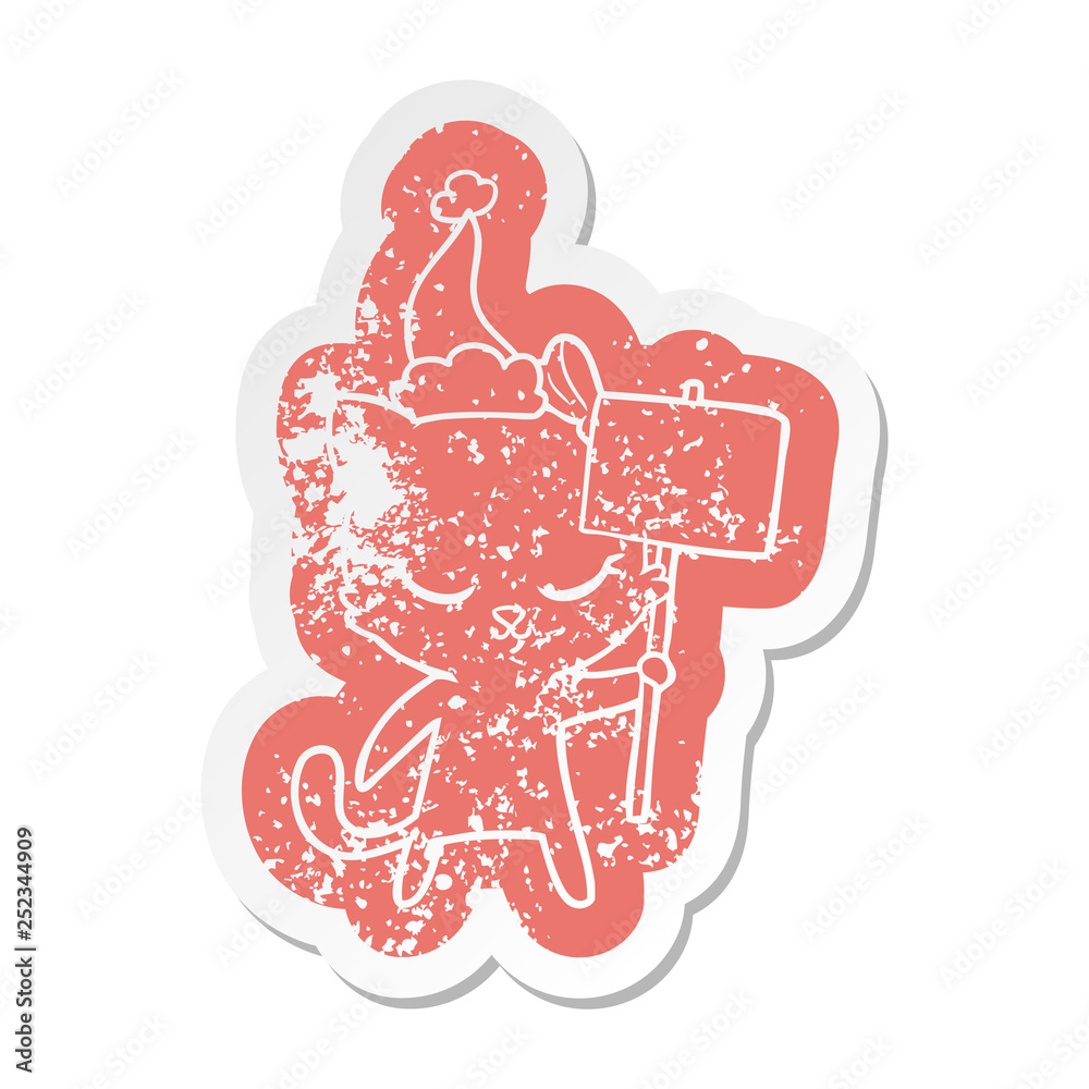 cute cartoon distressed sticker of a cat with sign wearing santa hat cute cartoon distressed sticker of a cat with sign wearing santa hat