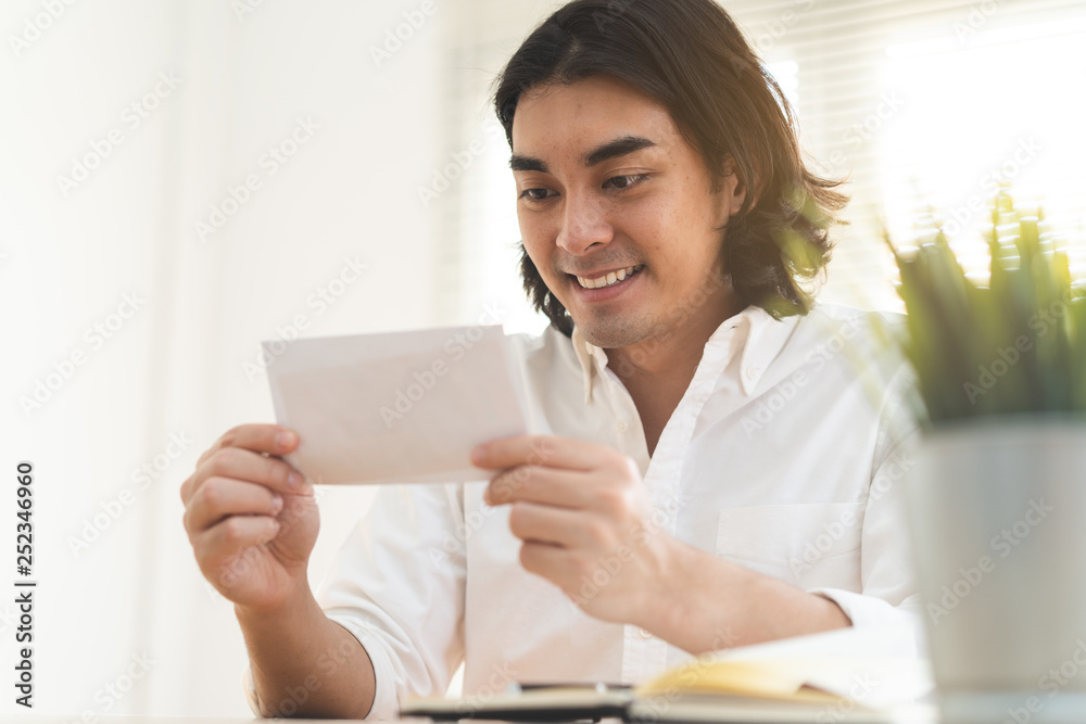 asian worker looking at bonus money from boss. asian worker looking at bonus money from boss.