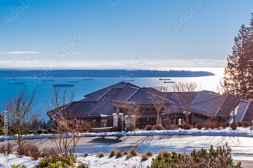 Houses in suburb at Winter with ocean view in the north America. Luxury houses covered nice snow.
