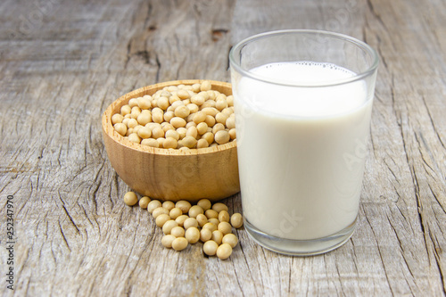 soy milk with soybean on wooden background.