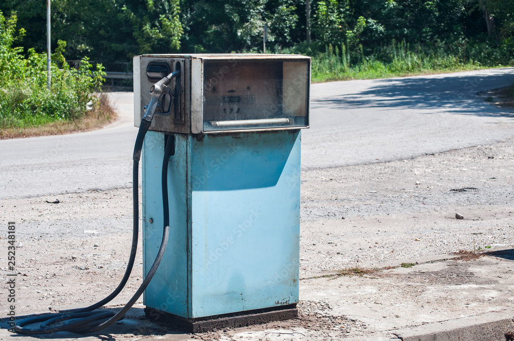 Old abandoned vintage obsolete petrol fuel gas dispenser in former