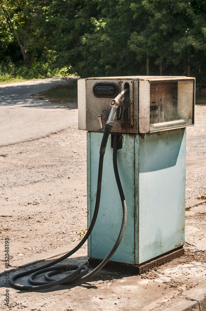 Old abandoned vintage obsolete petrol fuel gas dispenser in former