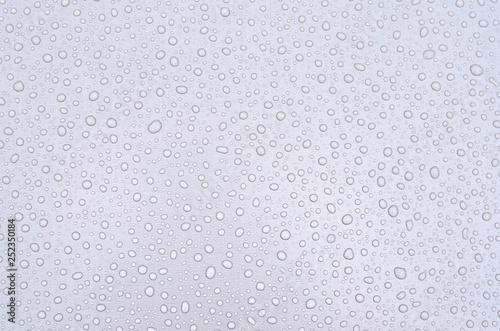 Raindrops on a flat surface as an abstract background. 