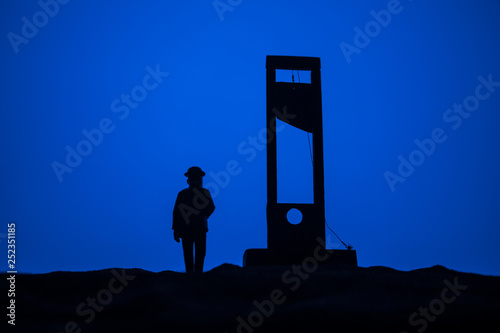 Horror view of Guillotine. Close-up of a guillotine on a dark foggy background. photo