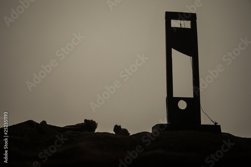 Horror view of Guillotine. Close-up of a guillotine on a dark foggy background.