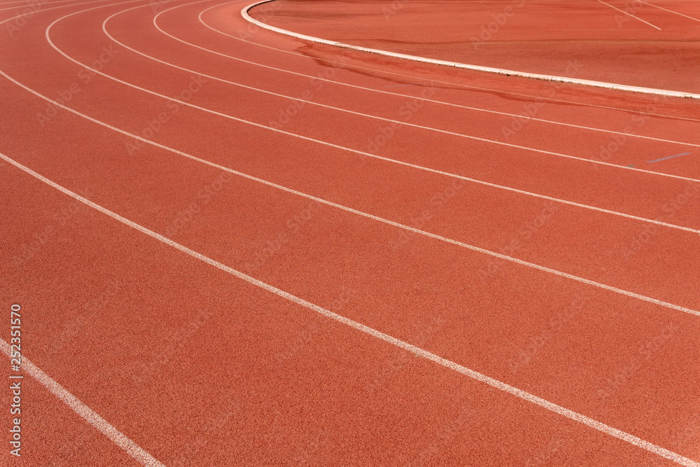 Red running track in stadium.