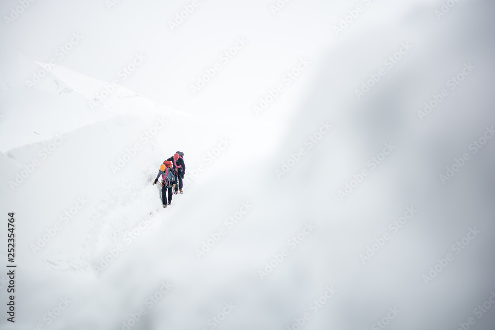 two people hiking mountains snow