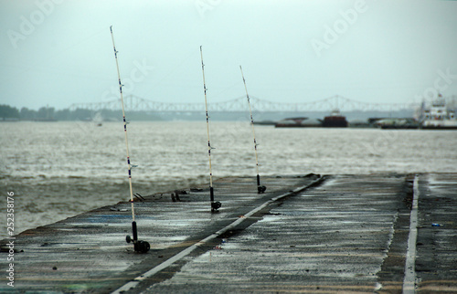 Fishing rods by the Mississippi river, with part of the Baton Rouge coast in the background, Louisiana, USA