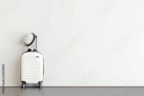Canvas Print White suitcase with hat and sunglasses  in airport departure lounge