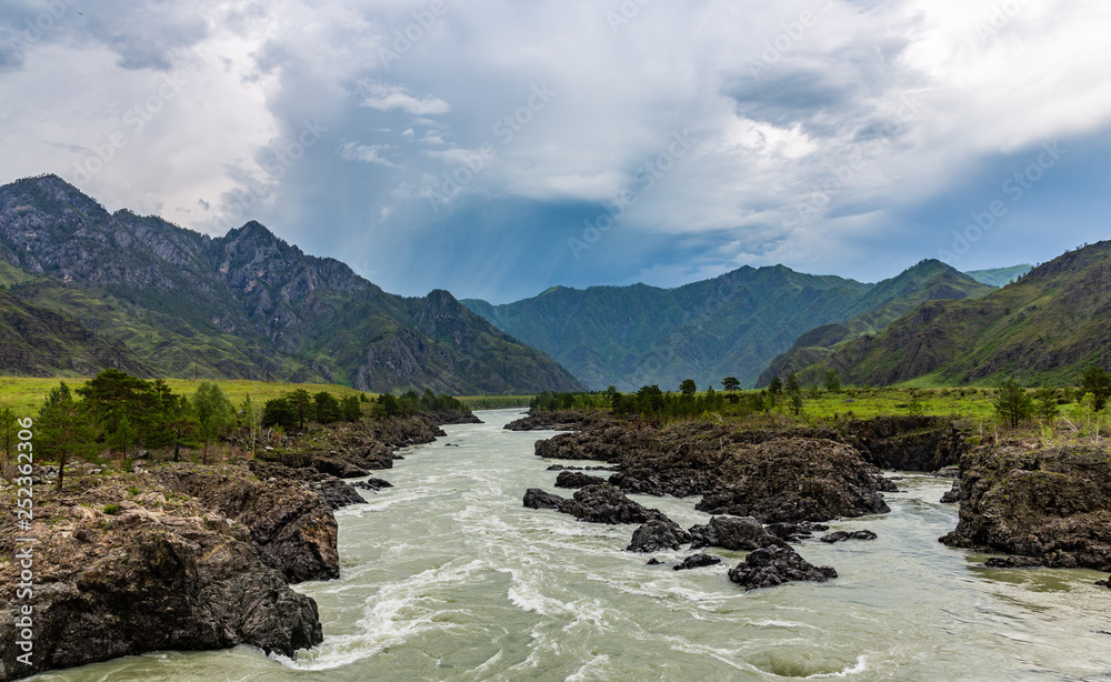 Fototapeta premium Dramatic thunderstorm clouds over the mountains in the upper reaches of the Katun River in the Altai