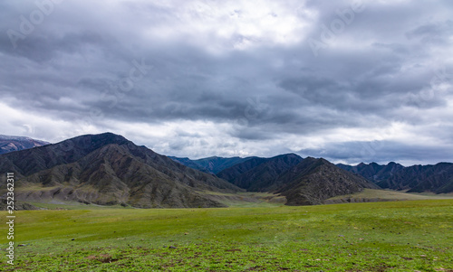 Dramatic clouds over the steppe and mountain peaks in the Altai