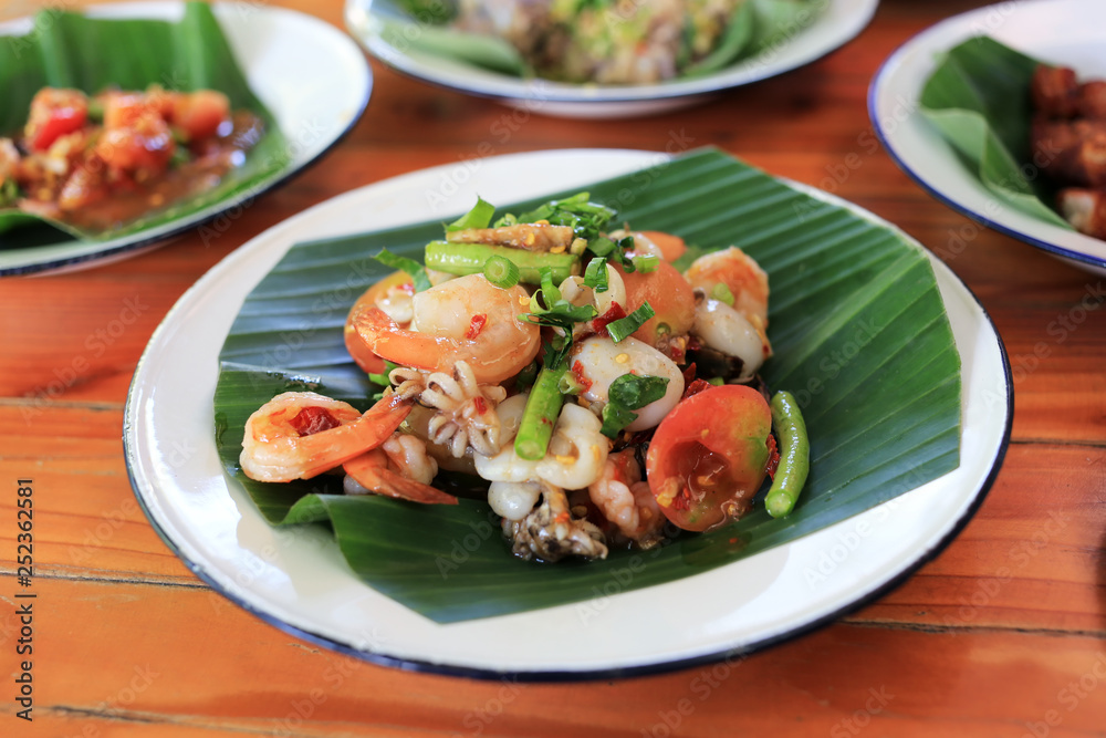 Seafood papaya spicy salad Thai traditional food “Som Tum” 