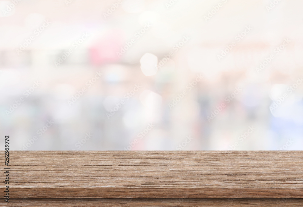 Empty wood table top on blur abstract background from inside shopping mall. Template mock up for display of product