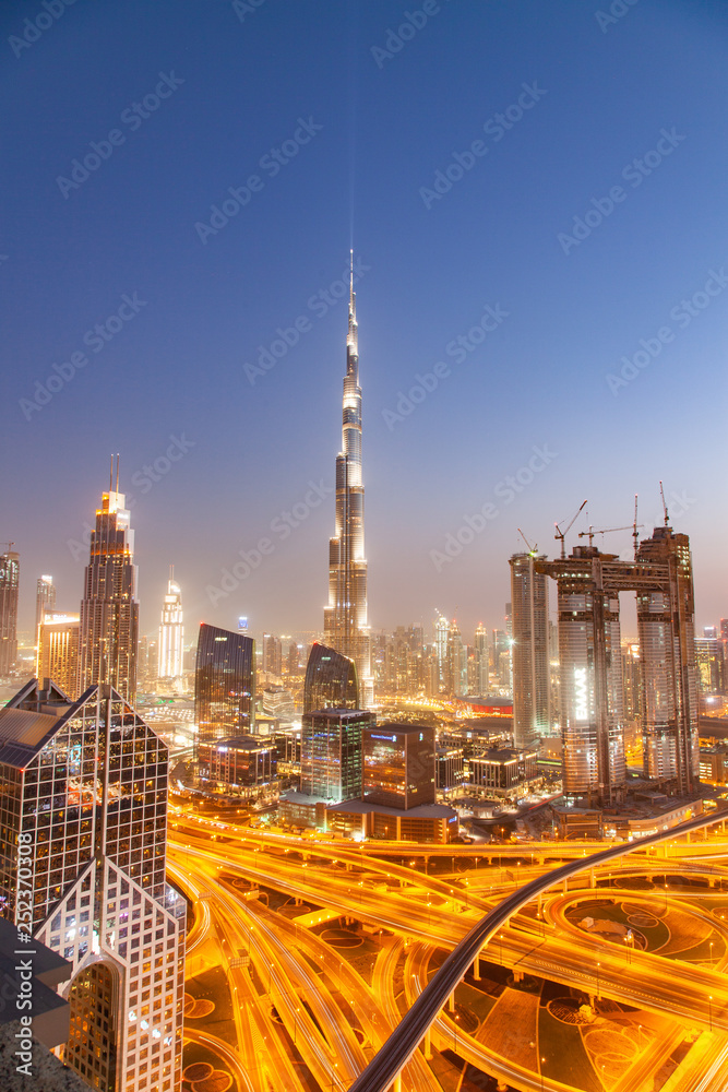 DUBAI, UAE - FEBRUARY 16: Burj Khalifa the tallest building in the world. Dubai Downtown cityscape. Dubai evening skyline, busy Sheikh Zayed road intersection, sunset on February 16, 2018 in Dubai