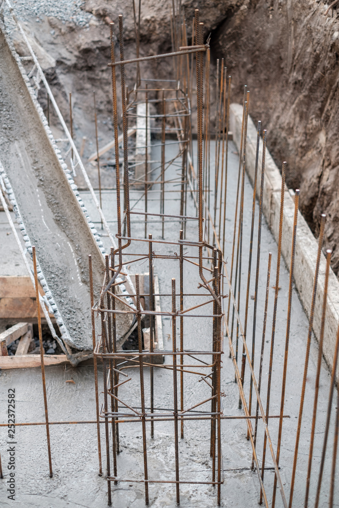 construction of the building, concrete pouring of metal reinforcement cages of foundations