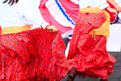 Close up of a mexican red dress during a dancing, colorful mexican background photo