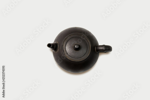 Black metal oriental traditional teapot isolated on soft gray background. Top view with copy space.high resolution photo.