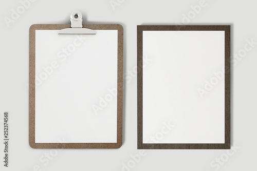 A wooden clipboard with a blank piece of paper (with clipping path) on soft gray background.